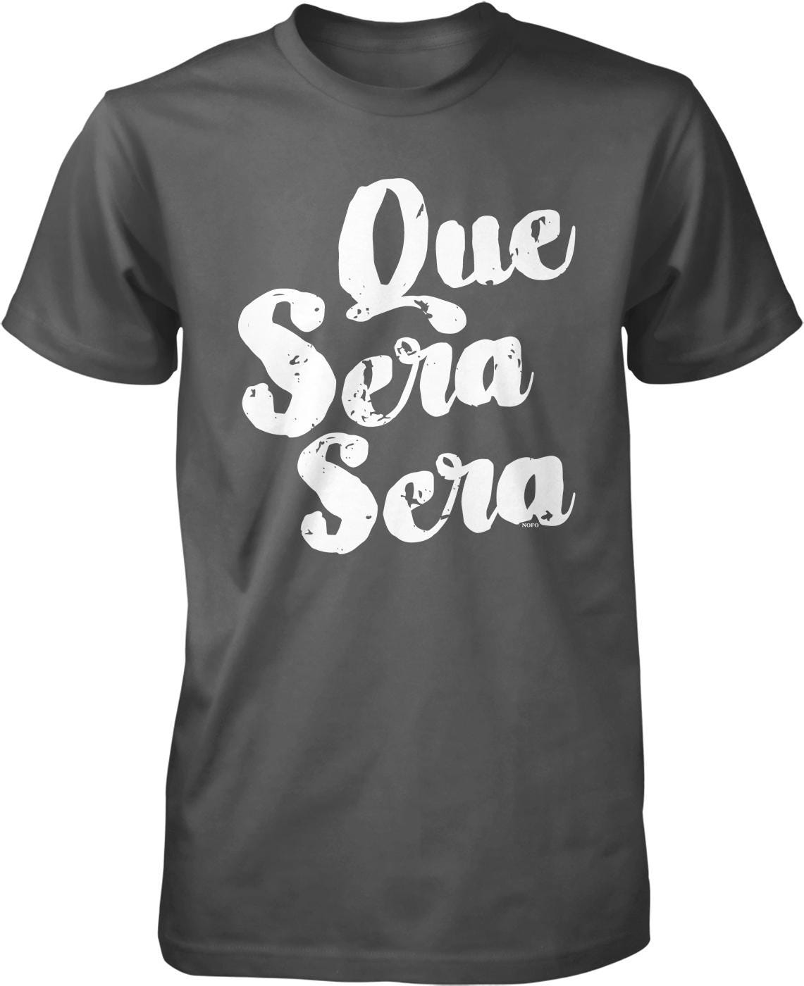 A black t-shirt with white text that reads "Que sera sera" printed on it.
