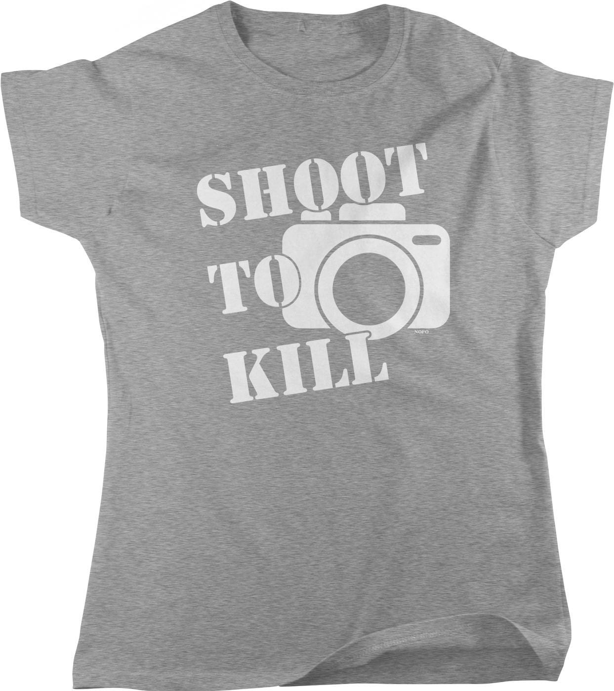 A gray t-shirt with the text "SHOOT TO KILL" printed on it, along with a graphic of a camera.