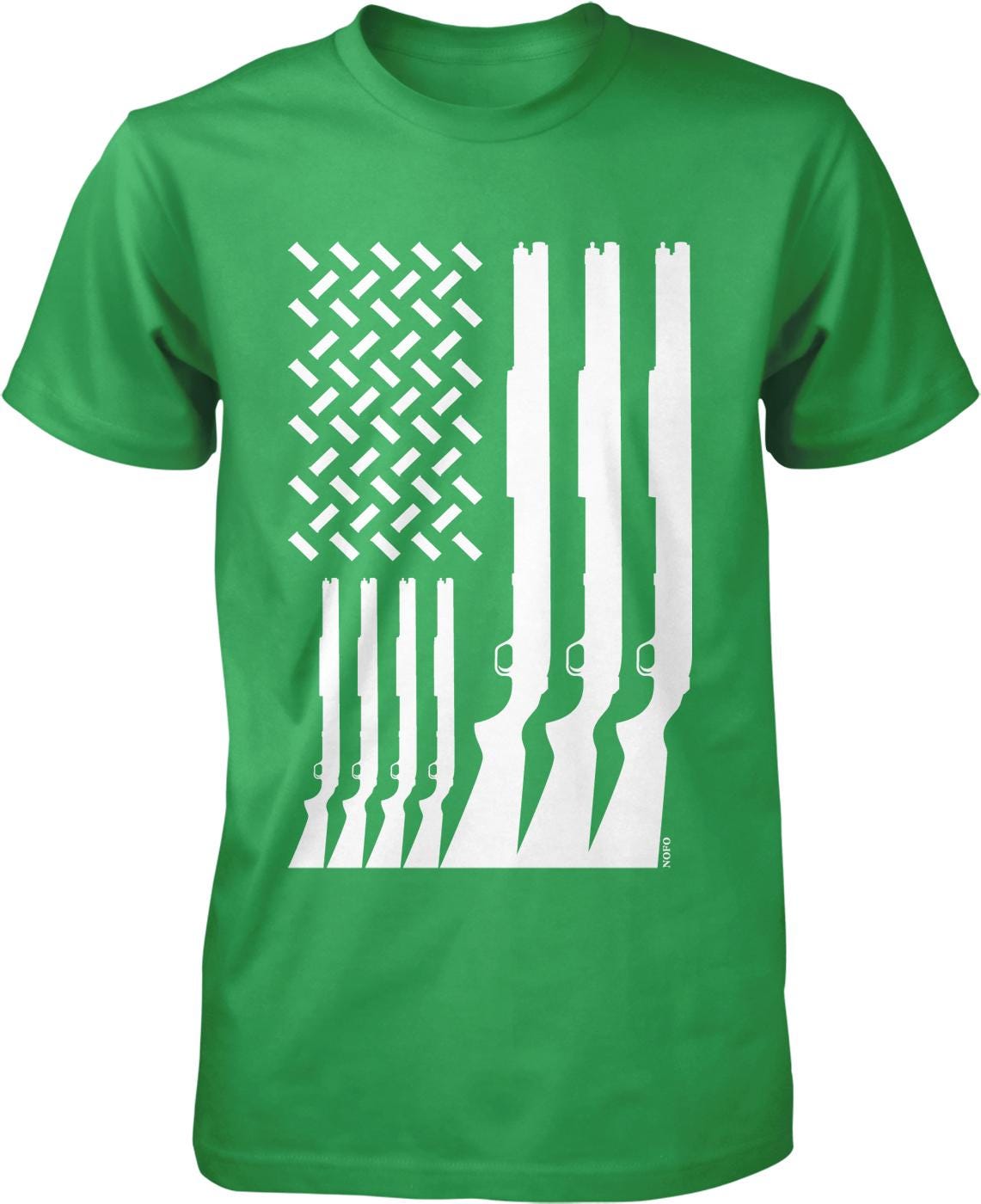 A green t-shirt with a graphic design depicting a pattern of white rifle silhouettes arranged in a diagonal line, resembling the American flag.