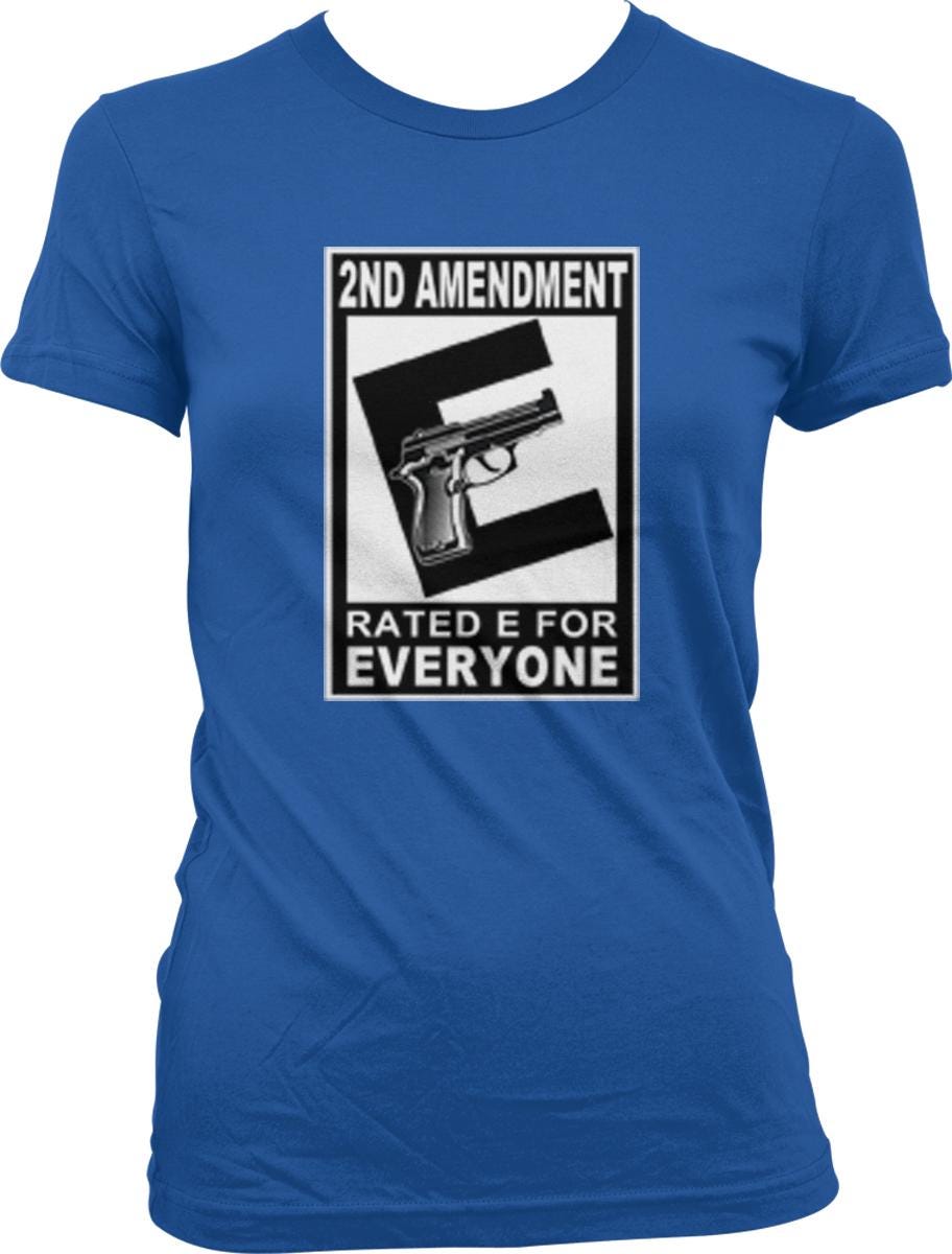 A blue t-shirt with a graphic design that says "2ND AMENDMENT RATED E FOR EVERYONE" and features a gun.