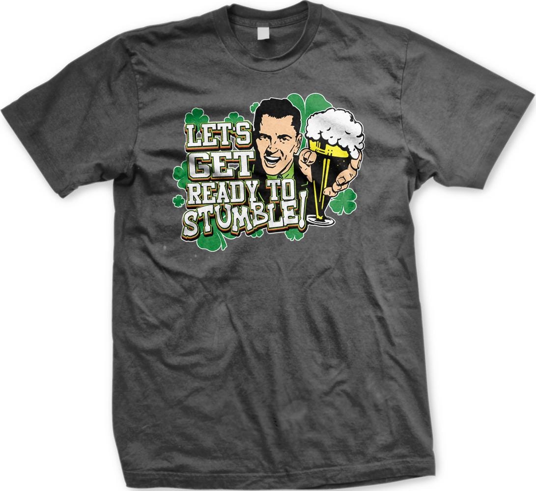 A gray t-shirt with a graphic design featuring a smiling man holding a beer and the text "Let's get ready to stumble!"