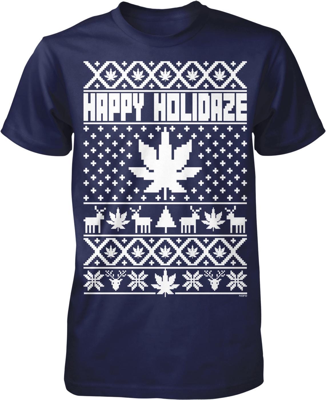A navy blue t-shirt with a white Christmas-themed design. The design includes a central Christmas tree, snowflakes, reindeer, and other holiday-related elements. The text "HAPPY HOLIDAZE" is prominently displayed across the top of the design.
