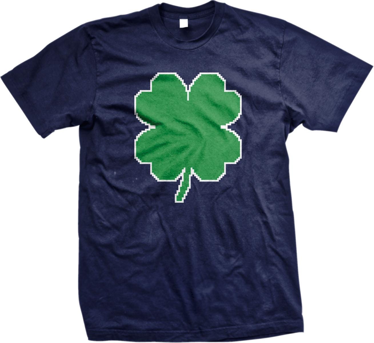A navy blue t-shirt with a green pixelated four-leaf clover design printed on it.