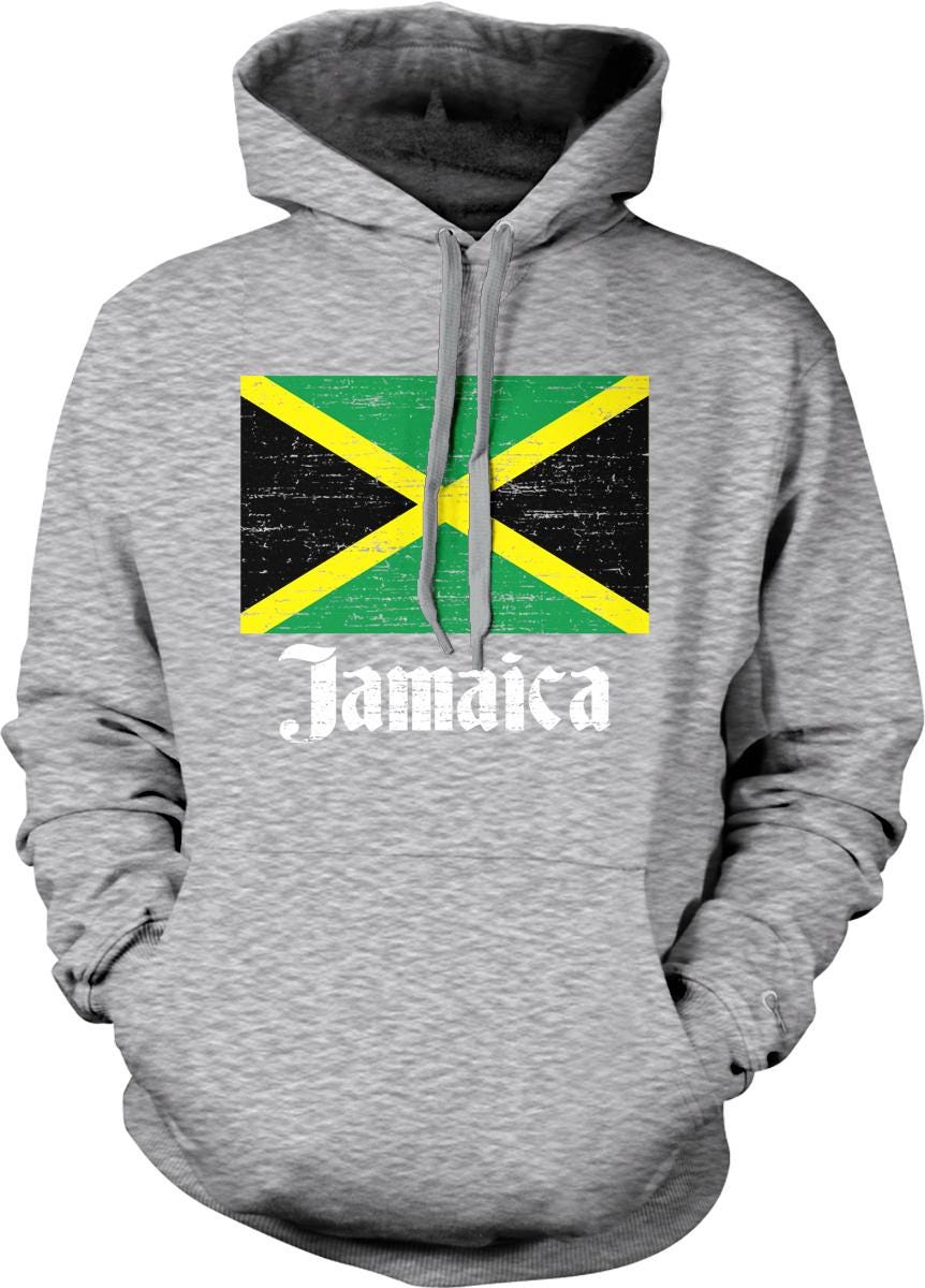 A grey hoodie with a graphic of the Jamaican flag and the word "Jamaica" printed on it.
