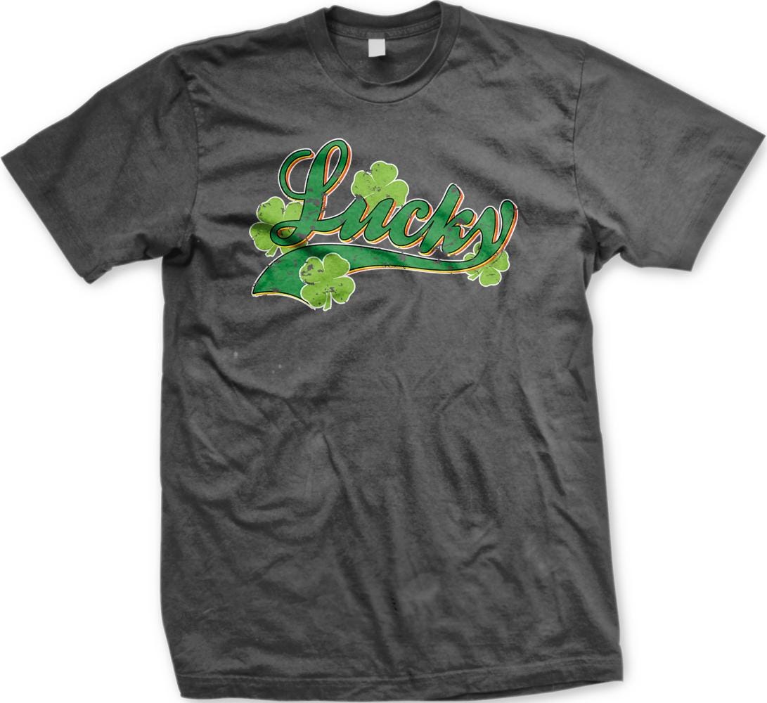 A gray t-shirt with a graphic design featuring the word "Lucky" and four shamrocks.