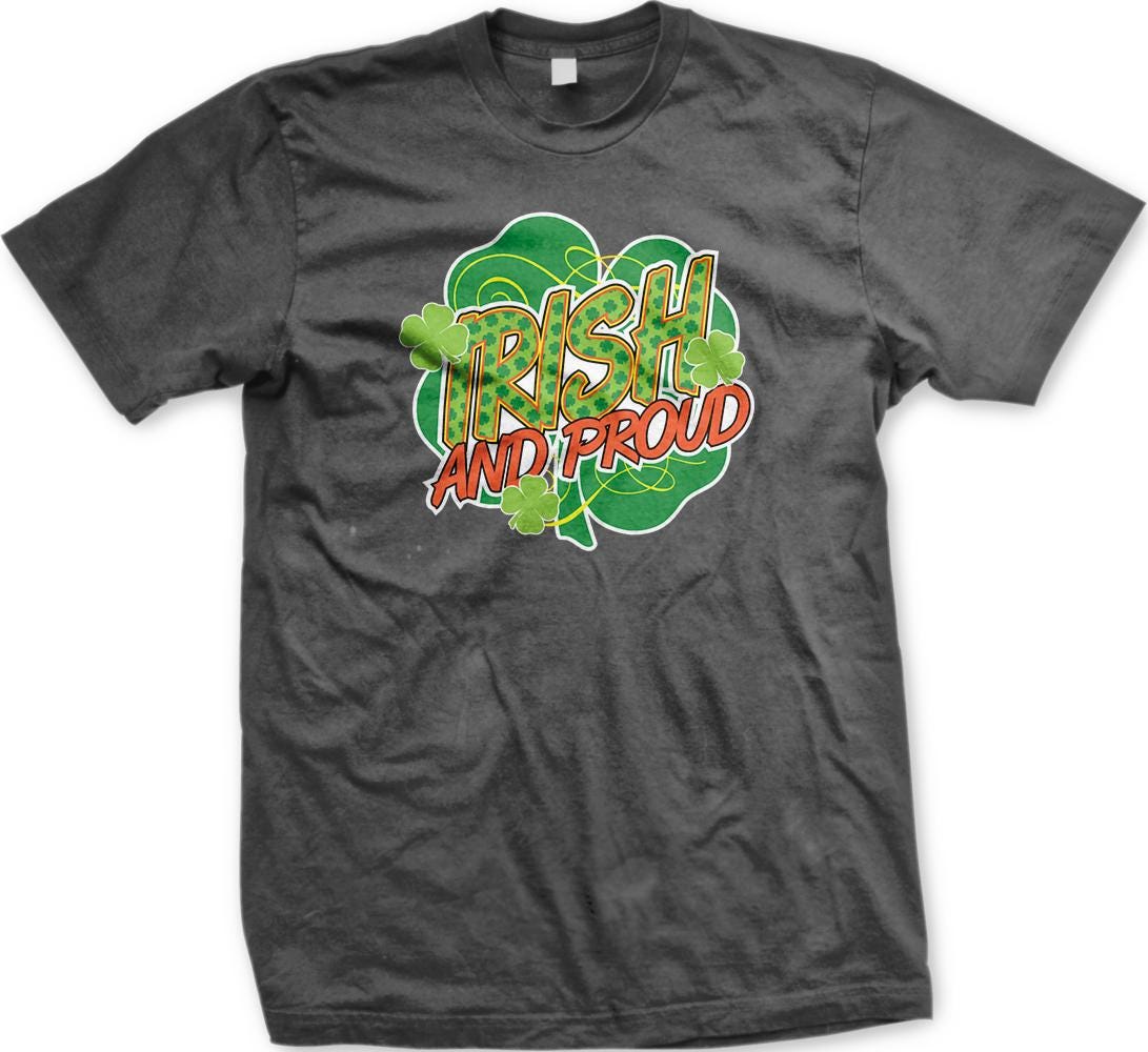 A grey t-shirt with a graphic design featuring the text "Irish and proud" surrounded by a shamrock and other shamrocks.